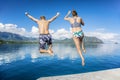 People jumping into the ocean while on a beautiful scenic Hawaiian vacation