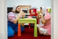 Man and woman like baby playing with plastic tableware Royalty Free Stock Photo