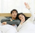 Man and woman lovers laying on bed and sharing sweet time together in winter season Royalty Free Stock Photo