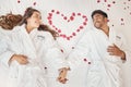 Man and woman married couple on luxury bed celebrate honeymoon, love and relax in romantic vacation spa hotel. Happy Royalty Free Stock Photo