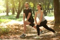 Man and woman doing morning exercise in park