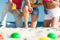 Man and women playing boule on beach