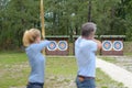 Man and woman practicing archery Royalty Free Stock Photo