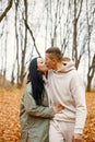 Lovely couple standing in autumn forest and kissing Royalty Free Stock Photo