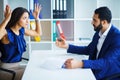 Man and woman staring at each other with hostile expressions. Royalty Free Stock Photo