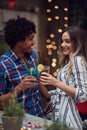 Man and a woman toast in outdoor bar with cocktails. multiethnic, friendship, couple, fun, joy, socializing, concept Royalty Free Stock Photo