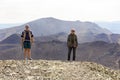Man and woman tourists stand on the top of Poklonnaya Gora against the background of Mount Karabash on a summer day. Chelyabinsk r Royalty Free Stock Photo