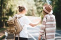 Ypung hipster couple hiking on forest road Royalty Free Stock Photo