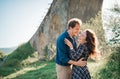 Happy joyfull young couple laughing outdoors at sunset