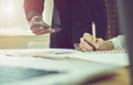 Man and women working on wooden desk in office in morning light. The concept of modern work with advanced technology. vintage effe Royalty Free Stock Photo