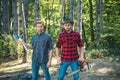 Man woodcutter holding ax. Axe in lumberjack hands cutting wood. Lumberman with a chainsaw in forest. Concept of a Royalty Free Stock Photo