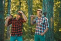 Man woodcutter holding ax. Axe in lumberjack hands cutting wood. Lumberman with a chainsaw in forest. Concept of a Royalty Free Stock Photo