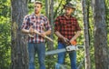 Man woodcutter holding ax. Axe in lumberjack hands cutting wood. Lumberman with a chainsaw in forest. Concept of a Royalty Free Stock Photo