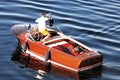 Man in wooden motorboat