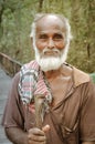 Man with wooden stick in Bangladesh