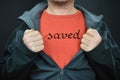 A man with the word saved on his t-shirt