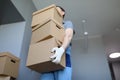 Man work clothes and gloves carries cardboard boxes Royalty Free Stock Photo