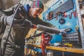 A man worker repairs in the ski service workshop the sliding surface of the skis, Base polishing, final ski polishing. In the hand