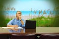 Man at work daydreaming about beautiful peaceful beach vacation Royalty Free Stock Photo