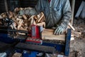 Man with work gloves cuts firewood with hydraulic log splitter Royalty Free Stock Photo