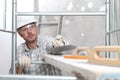 Man work, professional construction worker  with plastering tools on scaffolding, safety hard hat, gloves and protective glasses. Royalty Free Stock Photo