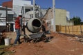 Man, construction worker using cement mixer, Brazil, south America , panoramic photo, selective focus, pouring cement Royalty Free Stock Photo