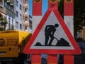 Man At Work Sign On Road