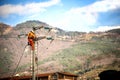 Man at work. Technician are repairing high voltage transmission systems on the power poles.