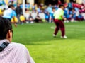 Man in work uniform Watch the football competitions beside football field