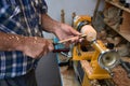 The woodturner work. Man`s arms with cutter in action. Royalty Free Stock Photo