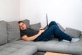 The man worked at home behind a laptop tired and sleeps on the couch Royalty Free Stock Photo