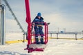 Man worker in a boom lift, machine control on the aerial platform Royalty Free Stock Photo