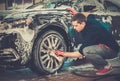 Man worker on a car wash Royalty Free Stock Photo