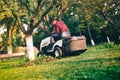 Man worker carefully trimming lawn. Grass cutter occupation in industrial field Royalty Free Stock Photo