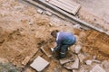 Man worker carries a heavy stone with his hands. manual labor concept