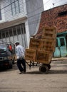 a man worker carrying goods on a trolley carrying goods at a traditional market