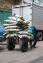 a man worker carrying goods on a trolley carrying goods at a traditional market