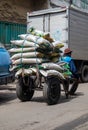 a man worker carrying goods on a trolley carrying goods at a traditional market