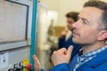 Man worker checking advanced industrial control panel