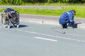 A man worker cleans a marble electric curb with an electric hand grinder.