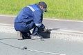 A man worker cleans a marble electric curb with an electric hand grinder.