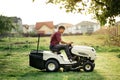 man worker cutting grass with lawn mower, lawn care concept. Industrial details