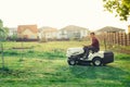 man worker cutting grass with lawn mower, lawncare concept. Industrial details