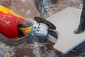 Man worker cutting tile with circular saw Royalty Free Stock Photo