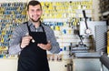 Man worker displaying result of his key making in workshop Royalty Free Stock Photo