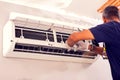 Man worker fixing air conditioning on the wall