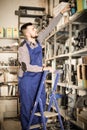 Man worker going through sanitary engineering details in workshop Royalty Free Stock Photo