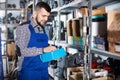 Man worker going through sanitary engineering details in workshop Royalty Free Stock Photo