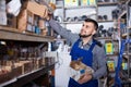 Man worker going through sanitary engineering details in workshop Royalty Free Stock Photo