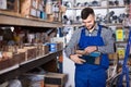 Man worker going through sanitary engineering details in workshop Royalty Free Stock Photo